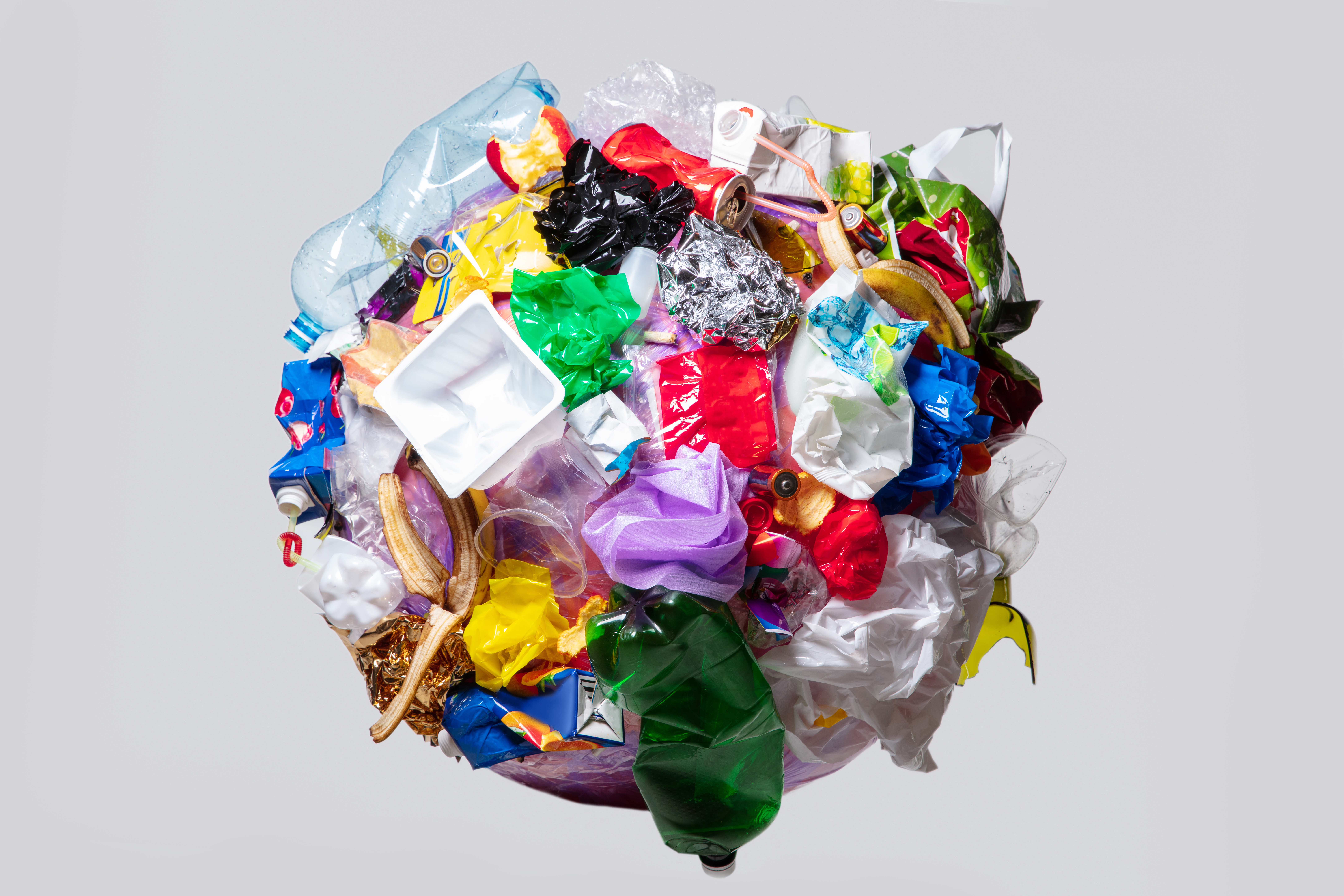 Protect your family from toxic plastics. A sphere of crushed plastics in the shape of the earth.